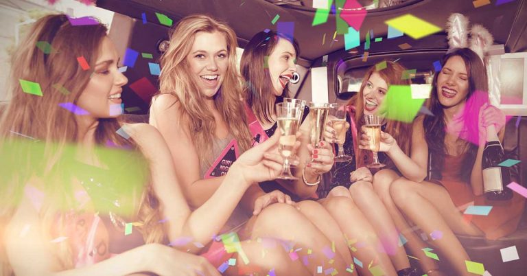 Group of women in the back of a limo celebrating a hens party.