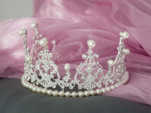 Gorgeous silver tiara with peals sitting on pink veil